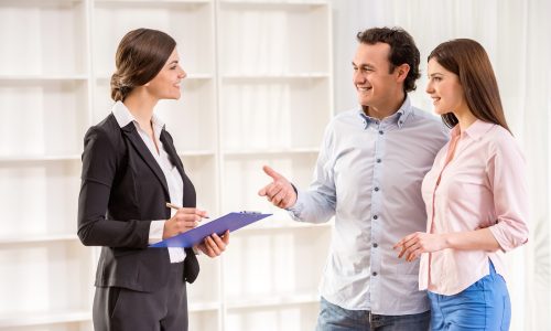 Young couple are talking to real estate agent.